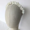 Couronne de fleurs coiffure mariage Mathilde. Petites fleurs blanches de porcelaine et perles nacrées.