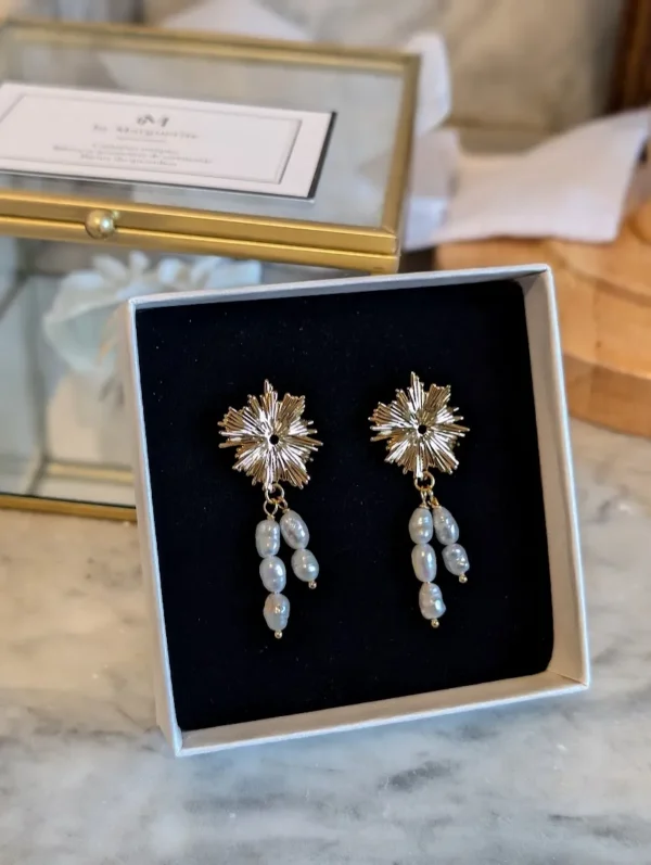Boucles d'oreilles ALBANE dans leur écrin : puce soleil dorée à l'or fin et perles d'eau douce naturelles pendantes, by Marguerite