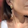 Boucles d'oreilles pendantes asymétriques. Coquillage doré et perles baroques